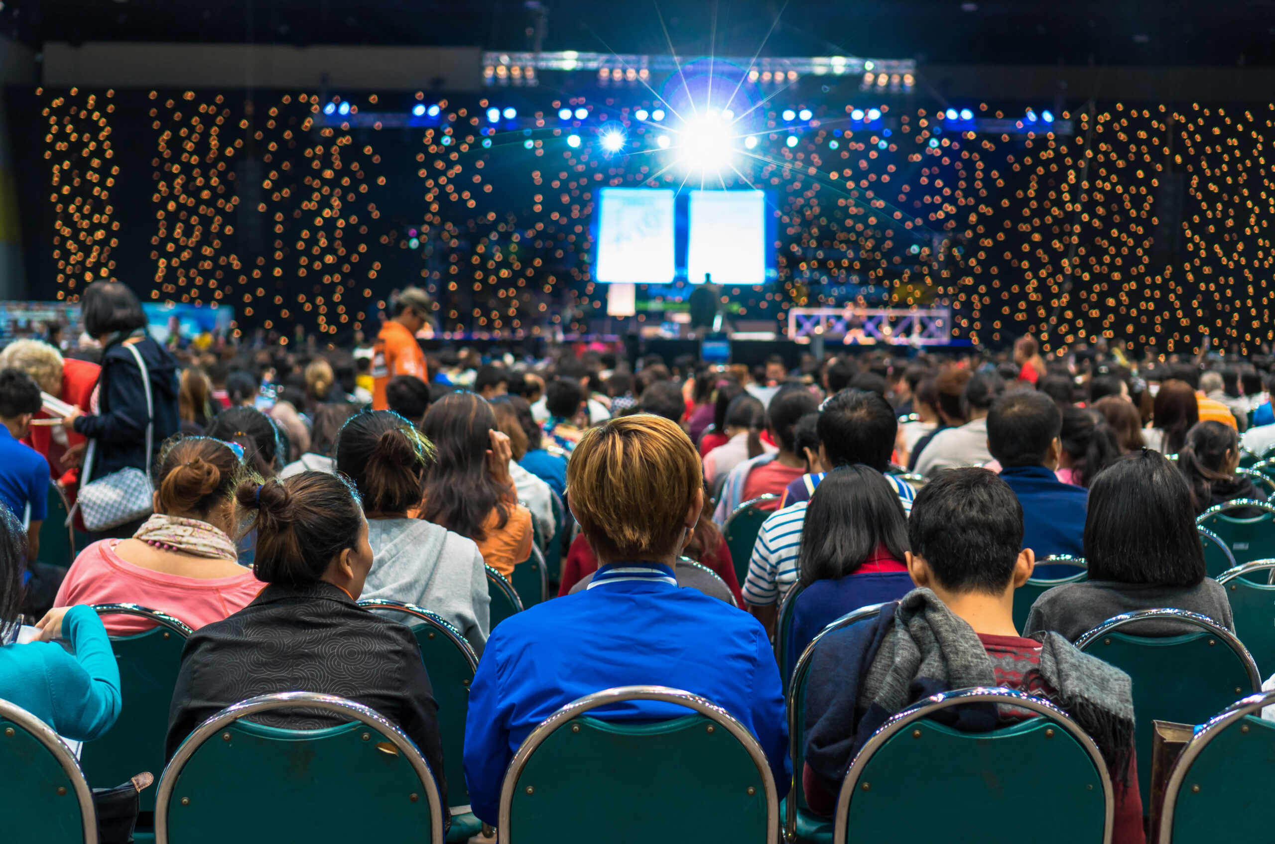 Rear view of Audience in the conference hall or seminar meeting Rear view of Audience in the conference hall or seminar meeting which have Speakers on the stage, business and education about investment concept